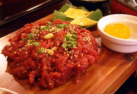 yukhoe: one of a variety of hoe (raw dishes in Korean cuisine), which are usually made from raw ground beef...