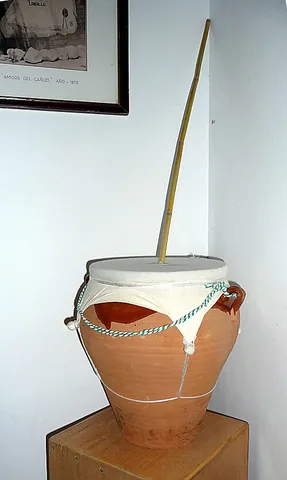zambomba: a Spanish friction drum, consisting of a ceramic pot with a skin and a pole in the middle. To play...
