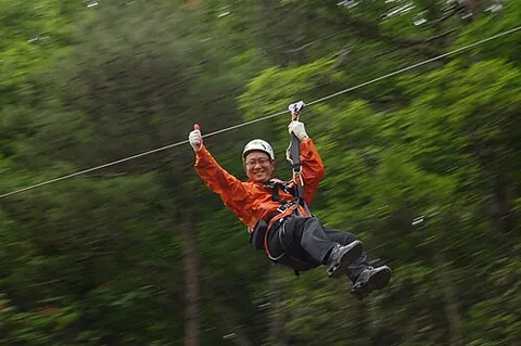 zipline: a pulley suspended on a cable mounted on an incline, designed to enable a user to travel from one...