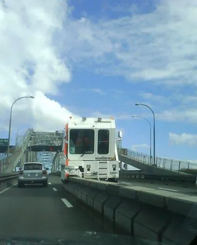 zipper machine: a heavy vehicle used to transfer concrete lane dividers on a roadway