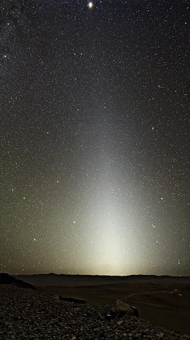 zodiacal light: a soft glow of white light seen in the sky along the ecliptic in an elongated triangular form with...